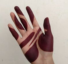 a person's hand painted with red paint