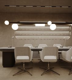 a table with four chairs in front of it and three lights hanging from the ceiling