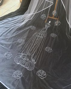 a black sheet with white drawings on it sitting in front of a window and door