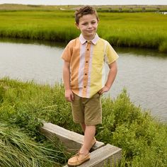 Sunrise Vibes! Shades of purple, orange and yellow evoke the early morning light in Pink Chicken's warm and colorful Desert Stripe seen here on their collection classic Boys Jack Shirt. This short sleeve, collared staple features a roomy pattern on pattern front chest pocket, a faux coconut button front closure and their signature bright blue thread detail on the top button. Short sleeve Collared One front pocket at chest Faux coconut buttons Machine wash cold, gentle cycle, hang to dry, cool ir Boys Collared Shirt Pattern, Orange Short Sleeve Shirt For Spring, Yellow Collared Short Sleeve Shirt For Spring, Multicolor Cotton Short Sleeve Shirt For Spring, Brown Cotton Short Sleeve Shirt For Spring, Spring Brown Cotton Short Sleeve Shirt, Yellow Cotton Short Sleeve Shirt For Summer, Summer Yellow Cotton Short Sleeve Shirt, Multicolor Collared Cotton Short Sleeve Shirt