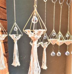 the hanging ornaments are made from glass beads and tasseled with chains, which hang on wooden planks