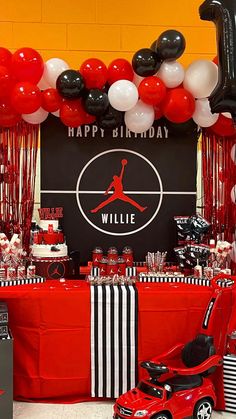 an air jordan themed birthday party with balloons, decorations and table cloths on the floor