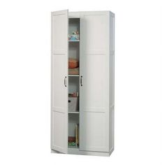 a tall white cabinet with two doors and shelves on the bottom shelf is open for storage