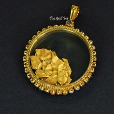 DESCRIPTION: Thank you for coming in! Unique Navratna 18k yellow gold pendant shaker locket! This piece has 4 sets of the 9 Navratna gemstones set into a spinning layer around the edge of the pendant. The middle is enclosed in sapphire glass and contains many loose 24k solid gold foil flakes that bounce around merrily inside! You'll get the Navratna pendant you see! SIZE: 50.7mmx37mmx6.7mm Bail: 9.3mmx6.7mm, 5.2mm hole Weight: 18.88 grams MATERIAL: 18k Solid yellow gold, 24k gold foil Gemstones: Yellow Gold Round Jewelry, 22k Gold Amulet Locket Jewelry, 22k Gold Locket Jewelry, Spiritual 22k Gold Locket Jewelry, Antique Gold Openable Jewelry, Yellow 22k Gold Round Pendant Jewelry, Traditional Yellow Locket Jewelry, Navratna Pendant, Yellow Gold Pendants