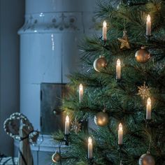 a christmas tree with lit candles in it