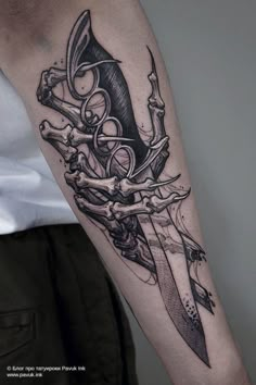 a man with a tattoo on his arm holding a knife