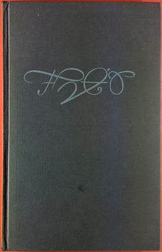 an old black book with white writing on the front and back cover that says,