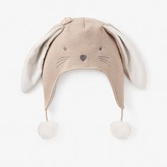 a beige bunny hat with ears on it