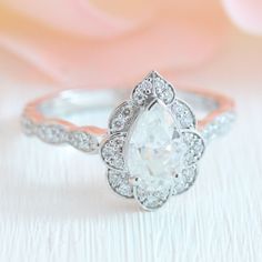 an engagement ring with a pear shaped diamond in the center