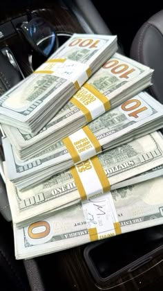 stacks of money sitting in the center console of a car