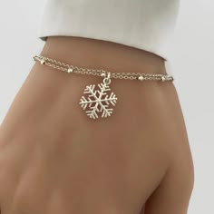 "Pictures are enlarged to show details of the item. Please refer to original size and measurements in the following description  Beautiful sterling silver snowflake bracelet.  A perfect addition to your winter jewellery collection or a gift for your loved one.  Details: - Material metal: sterling silver - Snowflake charm measures 15mm - Adjustable bracelet length from 6.5\" to 7.5\", adjustable anklet length (approx. 8.5\" to 9.5\"). Prefer different length? Please leave a note during checkout. PERSONALIZATION: Add an initial charm here: https://etsy.me/2vqe7pr Add a sterling silver cubic zirconia birthstone here: https://etsy.me/2O4TBFR Add a Swarovski crystal birthstone here: https://etsy.me/2zSgJyA Add a necklace chain extender: https://etsy.me/2yGaa06 ENTER OUR SHOP HERE for more jewel Frozen Jewelry, Winter Jewellery, Winter Bracelet, Aesthetic Bracelet, Bracelet Aesthetic, Snow Drop