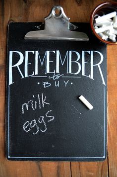 a clipboard with the words remember written on it next to a cup of sugar