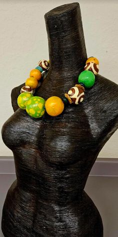 Even though this is a new listing, I am placing it in the FINAL SALE collection since I am not entirely pleased with the way the paint behaved on this piece. Large and oversized hand sculpted beads are painted in a variety of colors: orange with a color shift glaze, green and yellow polka dot with a color shift glaze, lime green, African batik patterned beads, agate, coconut, resin and African glass. Most beads are separated with tiny turquoise spacers. The sculpted beads are sealed with a satin Artisan Green Hand Painted Necklaces, Green Wooden Beads Necklaces For Festivals, Green Hand Painted Artisan Necklace, Artisan Hand Painted Green Necklace, Artisan Green Hand Painted Necklace, Artistic Green Necklace For Festivals, Artistic Beaded Necklace With Large Beads, Artisan Yellow Necklaces With Wooden Beads, Artisan Yellow Necklace With Wooden Beads