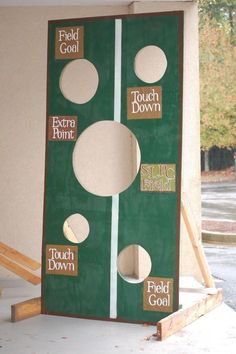 a large green board with holes in the middle and white circles on it's sides