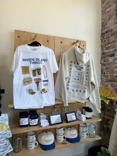 t - shirts and other items on display in a shop