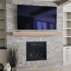 a fireplace with a flat screen tv mounted above it