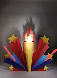 an open book with a lit candle in the middle and stars around it, on a gray background