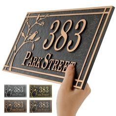 a person is holding up a plaque that says, 350 park street and three different numbers