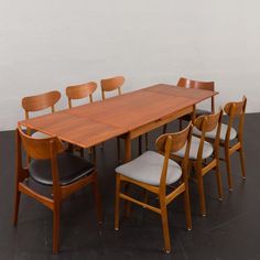 a wooden table with six chairs around it