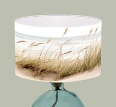 a blue glass table lamp with grass on it