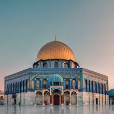 the dome of an old building with blue and gold tiles on it's sides