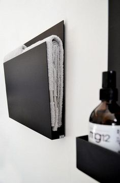 a black and white photo hanging on the wall next to a soap dispenser