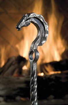 a metal hook with a fire in the background