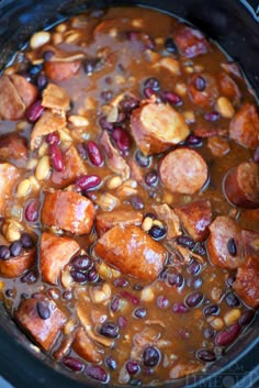 a crock pot filled with beans and sausage