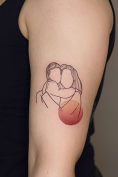 a woman's arm with a small tattoo on it that shows two people hugging