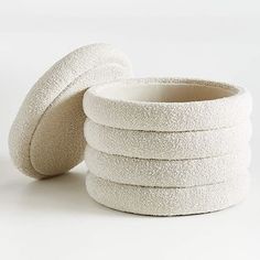 a stack of white round bowls sitting on top of each other