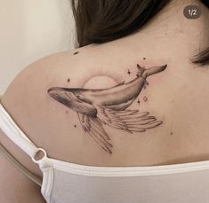 a woman with a whale tattoo on her shoulder