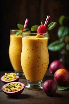 two glasses filled with smoothie next to fruit