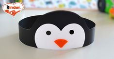 a black and white penguin headband sitting on top of a table