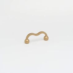 a gold ring with two balls on it