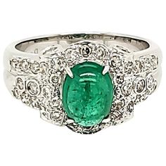 Emerald Cabochon And Diamond White Gold Engagement Ring: A bright green Emerald Cabochon weighing 1.47 carat accented by a variety of White Diamonds of fine quality weighing 0.67 carat, this ring is a great option for an engagement ring! The emerald cabochon possess great lustre and transparency, coupled with a bright green colour that is visible even from afar! The design of the ring is contemporary and makes the ring look even more special and important. Fit for an engagement ring, it is also Luxury Emerald Cabochon Ring For Wedding, Elegant White Gold Cabochon Emerald Ring, Fine Jewelry White Gold Cabochon Emerald Ring, Luxury Emerald Cabochon Ring With Diamonds, White Gold Emerald Ring, Oval Cabochon, Emerald Cabochon, White Gold Engagement Ring, Simple Girl, White Gold Engagement