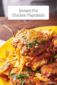 a yellow plate topped with pasta and meat covered in sauce, garnished with parsley