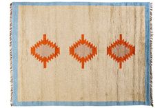 an orange and blue rug with three different designs on the front, two in the back