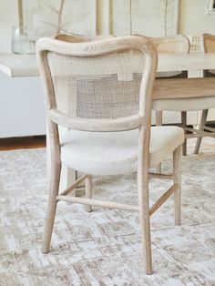 a dining room table with chairs and a rug