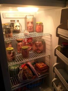 an open refrigerator filled with lots of food and jars on the shelves next to each other