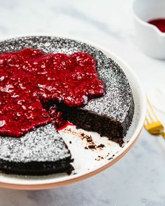 a piece of chocolate cake with raspberry sauce on top