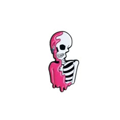 a pink and black skeleton pin sitting on top of a white surface