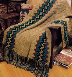 This is for a PDF pattern not the finished product. Fill a room with the warmth and beauty of the Painted Desert by draping this Southwestern throw over a chair or sofa. Long double crochets in alternating colors form an eye-catching geometric pattern, and generous fringe completes the look. Finished Size: 44" x 57" MATERIALS Red Heart Worsted Weight Yarn (8 ounces (452 yards) per skein]: Warm Brown - 5 skeins Rust - 1 skein Teal - 1 skein Black - 1 skein Crochet hook, size I (5.50 mm) or size n Crochet Afgans Patterns, Native American Crochet Patterns, Crochet Quilts, Afghan Crochet Patterns Easy, Crocheted Afghans, Afghans Crochet, Crochet Afghan Patterns Free, Indian Blankets, Crochet Afgans