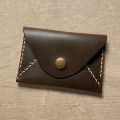 "Envelope snap wallet made from Horween Cavalier leather and hand-stitched (saddle stitch). Fits 4 cards comfortably, more after break-in period. Approximately 4\" x 2.75\"." Leather Envelope Card Holder, Brown Envelope Card Holder For Everyday Use, Formal Brown Wallet With Snap Closure, Leather Envelope Coin Purse With Coin Pocket, Leather Wallet With Snap Closure, Brown Leather Trifold Envelope Wallet, Brown Envelope Wallet With Card Slots, Brown Leather Envelope Trifold Wallet, Leather Trifold Wallet With Coin Pocket In Envelope Shape