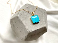 **Each piece in my shop, I personally create and photograph. (All photos are property of The Cord Gallery LLC) Thank you for supporting my small business. Turquoise never goes out of style and these Square Turquoise Pendant Necklaces are a great way to add a pop of color to any outfit. Features raw Turquoise, square cut, with a rounded edge, framed in gold electroplating. Hangs on your choice of chain.{Stones will be chosen at random to create your custom necklace} Chain Options:14k Gold Plated Untreated Turquoise Pendant Necklace For Gift, Untreated Turquoise Pendant Necklace Gift, Turquoise Square Pendant Necklace As Gift, Elegant Turquoise Square Pendant Necklaces, Turquoise Gemstone Square Pendant Jewelry, Raw Turquoise, Turquoise Pendant Necklace, Trendy Necklaces, Square Pendant