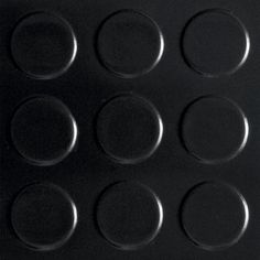 a black surface with circles on it