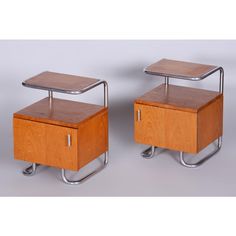 pair of mid century modern nightstands on casteors in oak and chrome, circa 1950's