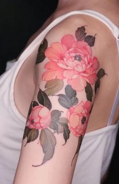 a woman with a flower tattoo on her arm