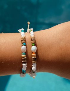 Featuring a mix of natural materials, our Midsummer Bracelet is unique and sure to make a statement on your wrist. Show off this style on the boardwalk with friends or add this to your beach outfit for a finished look. White chipped gemstones Puka shells Freshwater Pearl Blue Natural Gemstones Coconut Shell Wood Wax cord approx 6" with adjustable 3.5" knot - adjustable and waterproof! Mix and match with your favorite HALT pieces or wear alone for boho beach vibes. The perfect gift for her! Our jewelry is handmade in the Sunshine State with local materials and shipped with an effort to use environmentally friendly packaging, making it the perfect choice for those who shop with a green mindset. Vacation Accessories, Surfer Bracelets, Wood Wax, Puka Shell, Coconut Shell, Boho Beach, Boho Look, Perfect Gift For Her, Bracelet Gift