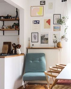 a living room filled with furniture and pictures on the wall