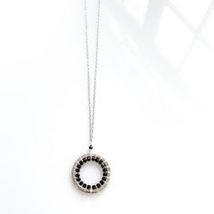 Free Shipping on our gorgeous, silver black spinel circle pendant necklace for women. Very lightweight and great for layering.  These are great graduation gifts, birthday gifts or bridesmaid gifts.- Black Spinel gemstones- Chain length can be adjusted from 16-18" with 2" extender chain- Spring ring clasp- Made in the USA in our New York City studio- Packaged with love and care in a gift boxMade of rhodium plated fine Italian silver. Stamped for authenticity. We use rhodium to resist tarnish and Adjustable Black Spinel Jewelry For Gifts, Handmade Black Circular Jewelry, Silver Black Spinel Jewelry As Gift, Silver Black Spinel Jewelry For Gift, Silver Black Spinel Jewelry Gift, Modern Wire Wrapped Round Jewelry, Modern Round Wire Wrapped Jewelry, Black Round Necklace For Everyday, Minimalist Black Spinel Necklace As Gift